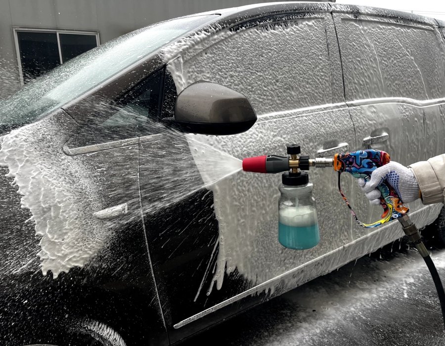 Thick foam pre-wash coating a vehicle before hand washing